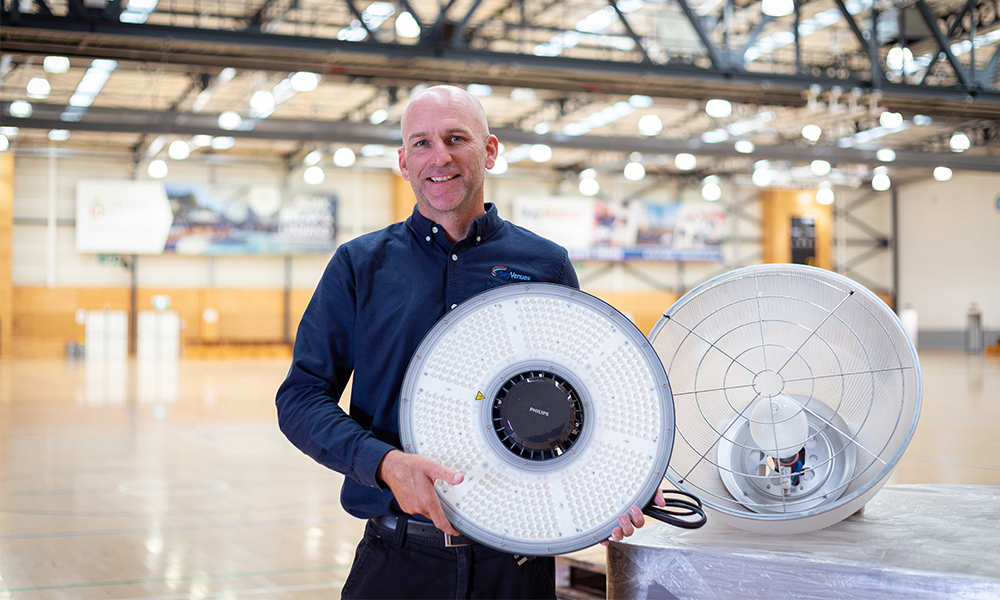 Bay Venues employee holding up energy efficient lights